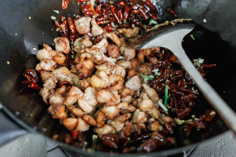 Edit Post Switch to draft Preview Update Image: Change block type or style Change alignment Chongqing Mala Chicken -Laziji Learn how to make crispy, hot, and numbing Chongqing-style dry-fried mala chicken with dried chili peppers and Sichuan peppercorn. It has a very distinctive local name - Laziji, meaning hot pepper chicken. It is acceptable hot and full of strong aroma bought by the peppers and aromatics. One of the best choices for a beer party. mala chicken, Laziji|chinasichuanfood.com Advanced Jump To heading 1 text text for heading 2 Where it comes from Chongqing Mala Chicken usually refers to Chongqing chicken with chili peppers and a spicy taste) and Sichuan peppercorns (numb feeling ). In Chinese, we call the dish Laziji, which mainly means dried chili pepper chicken. Some restaurants may call it Chongqing Chicken since it is thought to be quite popular in the Geleshan (歌乐山) area in the city of Chongqing. Although this one is less famous outside of Sichuan, it is considered even better than Kung Pao chicken by many Szechuan people. Rule No.1 - Don't eat the peppers There is a lovely description of the dish saying that you need to find chicken among chili peppers, which shows people’s love toward those savory chicken cubes and also how many chili peppers will be used in this dish. That’s 100% true in restaurant versions. For homemade mala chicken, I adjust the number of chili peppers so that we do not need to work so hard to find the meat. It gets another lovely name in my family called “mangrove forest”. In general, this dish is a dry fried dish. Dry-frying is a unique cooking method from Sichuan cuisine. Higher oil temperature helps to remove the extra water content inside the chicken, which further allows the mala flavor to permeate better. This is a very popular Sichuan-style cooking method and there are a group of dishes that share the same theory including dry-fried beef shreds and dry-fried green beans with minced pork. mala chicken - laziji|chinasichuanfood.com How to prepare the chicken We usually use chicken thighs for this dish because of the higher muscle content. Chicken breast is not recommended. In China, we usually cut the whole chicken into small chunks and cook it with bones. So it is ok to cut the thighs into small bites directly. But it is also quite caring to remove the bones for your guest. How to remove the bones of a chicken thigh: Prepare a kitchen scissor, find the loose side of the chicken thigh, and cut it apart. Then cut all the other connections on the bottom of the chicken thigh. Hold the thigh with one hand and then push all the meat down. And then use scissors to cut the left meat on the bone. Some tips for controlling the spicy taste Cut only part of the dried peppers into sections and keep the remaining as whole ones. Or you can use milder peppers directly. Remove the seeds after cutting the dried peppers apart Soak the peppers with water and then fry them over a slow fire for a short time can greatly reduce the natural spiciness, improve the aroma, and of course avoid burning them in the following steps. Can I use less chili pepper? You may wonder whether you can reduce the number of chili peppers when seeing this dish from the picture. Absolutely yes! I am reproducing the authentic Chongqing-style mala chicken, so a large number of peppers are needed. You can reduce the hot peppers and use only 15 to 20 dried peppers. Reducing the number of chili peppers will not influence the taste very much, but it can save lots of money if dried peppers are quite expensive. So sounds like a good idea definitely. But as a good blogger, I am trying to introduce the authentic version and this is the real version. Edit Post Switch to draft Preview Update Image: Change block type or style Change alignment Chongqing Mala Chicken -Laziji Learn how to make crispy, hot, and numbing Chongqing-style dry-fried mala chicken with dried chili peppers and Sichuan peppercorn. It has a very distinctive local name - Laziji, meaning hot pepper chicken. It is acceptable hot and full of strong aroma bought by the peppers and aromatics. One of the best choices for a beer party. mala chicken, Laziji|chinasichuanfood.com Where it comes from Chongqing Mala Chicken usually refers to Chongqing chicken with chili peppers and a spicy taste) and Sichuan peppercorns (numb feeling ). In Chinese, we call the dish Laziji, which mainly means dried chili pepper chicken. Some restaurants may call it Chongqing Chicken since it is thought to be quite popular in the Geleshan (歌乐山) area in the city of Chongqing. Although this one is less famous outside of Sichuan, it is considered even better than Kung Pao chicken by many Szechuan people. Rule No.1 - Don't eat the peppers There is a lovely description of the dish saying that you need to find chicken among chili peppers, which shows people’s love toward those savory chicken cubes and also how many chili peppers will be used in this dish. That’s 100% true in restaurant versions. For homemade mala chicken, I adjust the number of chili peppers so that we do not need to work so hard to find the meat. It gets another lovely name in my family called “mangrove forest”. In general, this dish is a dry fried dish. Dry-frying is a unique cooking method from Sichuan cuisine. Higher oil temperature helps to remove the extra water content inside the chicken, which further allows the mala flavor to permeate better. This is a very popular Sichuan-style cooking method and there are a group of dishes that share the same theory including dry-fried beef shreds and dry-fried green beans with minced pork. mala chicken - laziji|chinasichuanfood.com How to prepare the chicken We usually use chicken thighs for this dish because of the higher muscle content. Chicken breast is not recommended. In China, we usually cut the whole chicken into small chunks and cook it with bones. So it is ok to cut the thighs into small bites directly. But it is also quite caring to remove the bones for your guest. How to remove the bones of a chicken thigh: Prepare a kitchen scissor, find the loose side of the chicken thigh, and cut it apart. Then cut all the other connections on the bottom of the chicken thigh. Hold the thigh with one hand and then push all the meat down. And then use scissors to cut the left meat on the bone. Some tips for controlling the spicy taste Cut only part of the dried peppers into sections and keep the remaining as whole ones. Or you can use milder peppers directly. Remove the seeds after cutting the dried peppers apart Soak the peppers with water and then fry them over a slow fire for a short time can greatly reduce the natural spiciness, improve the aroma, and of course avoid burning them in the following steps. Reduce the amount of chili peppers You may wonder whether you can reduce the number of chili peppers when seeing this dish from the picture. Absolutely yes! I am reproducing the authentic Chongqing-style mala chicken, so a large number of peppers are needed. You can reduce the hot peppers and use only 15 to 20 dried peppers. Reducing the number of chili peppers will not influence the taste very much, but it can save lots of money if dried peppers are quite expensive. So sounds like a good idea definitely. Image Upload an image file, pick one from your media library, or add one with a URL. UploadMedia Library Insert from URL Ingredients 4 chicken thighs cook oil for frying 1 and 1/2 cups of chili peppers 1 and 1/2 tbsp. Sichuan peppercorn 1 root ginger, sliced 2 cloves garlic 2 scallions, white part, and a green part separated and cut into small sections 1 tsp. sugar 1 tbsp. sesame seeds, or a needed pinch of salt <div class="ERSSectionHead">Marinating</div> 1 tbsp. soy sauce 1 tbsp. rice wine ¼ tsp. white pepper powder 2 tsp. cornstarch (optional) small pinch of salt Steps Cut the dried chili peppers and then soak the peppers in water for 15 minutes. We are doing this so we can fry the peppers later and prevent burning the peppers. Mala chicken |chinasichuanfood.com Remove the bone of the chicken thighs and then cut them into small cubes. In a large bowl, marinade the chicken cubes with all the marinating sauce. Mix well and set aside for around 10 minutes. Mala chicken |chinasichuanfood.com Heat up oil in a wok or pan for deep-frying. Heat until really hot (you can see bubbles when you put a chopstick in). Add the chicken cubes in and fry until golden brown. Transfer out. I recommend using a pan and frying the chicken in batches. On one side, it uses less oil and on the other side, the chicken is widely touched with the bottom of the pan, which can speed up the process greatly. After adding the chicken cubes, let it stay for a short time (possibly about 40 seconds to 1 minute) until one side is browned, and then slightly stir the chicken and fry the other side. Mala chicken |chinasichuanfood.com Mala chicken |chinasichuanfood.com Get a clean wok and add only 1/2 tablespoon of oil and then fry the peppers for 1-2 minutes over the slowest fire until most of them become dark red. Add Sichuan peppercorn and continue frying for another 1 minute over the slowest fire. Mala chicken |chinasichuanfood.com Push the spices to one side and add 1/2 tablespoon of oil in wok and fry ginger, scallion white and garlic until aromatic. Mala chicken |chinasichuanfood.com Return the chicken cubes, and add roasted white sesame seeds, sugar, salt, and scallion green sections. Mix well and serve immediately. Mala chicken |chinasichuanfood.com Other yummy Chinese chicken recipes Kung pao chicken Mouthwatering chicken-- a famous spicy chicken in a spicy broth Cantonese roasted chicken--marinated with soy sauce and produce paper-thin skins. Chinese braised chicken with soy sauce -- this is a very popular way to cook chicken among the Chinese. And I add the baking step to improve the flavor and aroma to the next level. Mala Chicken Elaine Authentic Szechuan Chicken recipe—Mala Chicken 5 from 19 votes Print Recipe PREP TIME 20 MINS COOK TIME 17 MINS TOTAL TIME 37 MINS COURSE Main Course CUISINE Sichuan cuisine SERVINGS 2 CALORIES 499 kcal INGREDIENTS 1x 2x 3x ▢4 chicken thighs ▢cook oil for frying ▢1.5 cup chili peppers ▢1.5 tbsp. Sichuan peppercorn ▢1 root ginger ,sliced ▢2 cloves garlic ▢2 scallions ,white part and green part separated andcut into small sections ▢1 tsp. sugar ▢1 tbsp. sesame seeds ,or as needed ▢pinch of salt Marinating ▢1 tbsp. soy sauce ▢1 tbsp. rice wine ▢¼ tsp. white pepper powder ▢2 tsp. cornstarch ,optional ▢small pinch of salt INSTRUCTIONS Cut the dried chili peppers, discard the seeds and then soak the peppers in water for 15 minutes. We are doing this so we can fry the peppers later and prevent burn the peppers. Remove the bone of the chicken thighs and then cut into small cubes. In a large bowl, marinade the chicken cubes with all the marinating sauce. Mix well and set aside for around 10 minutes. Heat up oil in wok or pan for deep-frying. Heat until really hot (you can see bubbles when you put a chopstick in). Add the chicken cubes in and fry until golden brown. Transfer out. I recommend using a pan and fry the chicken by batches. On one side, it uses less oil and on the other side, the chicken is widely touched with the bottom of the pan, which can speed up the process greatly. After add the chicken cubes, let it stay for a short time (possible about 40 seconds to 1 minute) until one side is browed and then slightly stir the chicken and fry the other side. Get a clean wok and add only 1/2 tablespoon of oil and then fry the peppers for 1-2 minutes over slowest fire until most of them becomes dark red. Add Sichuan peppercorn in and continue frying for another 1 minute over slowest fire. Push the spices to one side and add 1/2 tablespoon of oil in wok and fry ginger, scallion white and garlic until aromatic. Return the chicken cubes, add roasted white sesame seeds, sugar, salt and scallion green sections. Mix well and serve immediately. NOTES The cornstarch used to marinade chicken can separate water and oil. So the chicken meat will be tender and simultaneously it can reduce the oil absorbed by chicken during deep-frying process. Recipe is firstly published in 2013 and updated with new details and pictures in 2017 NUTRITION Calories: 499kcal Carbohydrates: 38g Protein: 22g Fat: 29g Saturated Fat: 5g Cholesterol: 98mg Sodium: 520mg Potassium: 926mg Fiber: 11g Sugar: 14g Vitamin A: 7540IU Vitamin C: 10.9mg Calcium: 149mg Iron: 4.7mg KEYWORD chicken Tried this recipe? Mention @ChinaSichuanFood mala chicken|chinasichuanfood.com Toggle panel: AdThrive Ads Disable all ads Disable content ads Disable auto-insert video players Re-enable ads on All ads on this post will be enabled on the specified date Disable Video Metadata Disable adding metadata to video player on this post Toggle panel: Yoast SEO SEO Readability Schema Social Focus keyphraseHelp on choosing the perfect focus keyphrase(Opens in a new browser tab) Get related keyphrases(Opens in a new browser window) Google preview Preview as: Mobile resultDesktop result Url preview:www.chinasichuanfood.com › mala-chickenSEO title preview: Chongqing Mala Chicken -Laziji - China Sichuan Food Meta description preview: Oct 25, 2017 - Please provide a meta description by editing the snippet below. If you don’t, Google will try to find a relevant part of your post to show in the search results. SEO title Insert variable Title Page Separator Site title Slug mala-chicken Meta description Insert variable SEO analysisEnter a focus keyphrase to calculate the SEO score Premium SEO analysis Add related keyphrase Track SEO performance Cornerstone content Advanced Insights Toggle panel: Scripts Toggle panel: Page Specific Custom CSS Custom CSS Put your custom CSS that only applies to this one page, into this box. This keeps your site-wide "Additional CSS" small and uncluttered, which helps to boost pagespeed. Use the regular "Additional CSS" screen for any site-wide styling. Post Block Image Insert an image to make a visual statement. Styles Default Rounded Default Style Not set Advanced Skip to the selected block Open publish panel Post Image Notifications1 block added. Close dialog Select or Upload Media Upload filesMedia Library Filter mediaFilter by date All dates Search Media list Showing 80 of 8682 media items Load more ATTACHMENT DETAILS laziji-12.webp November 6, 2022 103 KB 800 by 1200 pixels Edit Image Delete permanently Alt Text Learn how to describe the purpose of the image(opens in a new tab). Leave empty if the image is purely decorative.Title laziji-12 Caption Description File URL: https://www.chinasichuanfood.com/wp-content/uploads/2017/10/laziji-12.webp Copy URL to clipboard Selected media actionsSelect Ingredients Chicken thighs - you can also use a whole chicken, and cut it into small bites. Cooking oil for shallow frying- I love to use the shallow frying method instead of pan-frying in home cooking because it saves more oil. But you need to cook the meat by batches. Dried chili peppers - you can use your familiar type. Just make sure this type is aromatic enough. Sichuan peppercorns - whole Sichuan peppercorns are used to create this lovely "ma" numbing feeling for your tongue. Garlic, ginger, and scallion - this three are always popular in Sichuan dishes. Sugar and salt - the foundation of a savory dish. Rice wine - for marinating the chicken White pepper powder - for marinating the chicken Steps Cut the dried chili peppers and then soak the peppers in water for 15 minutes. We are doing this so we can fry the peppers later and prevent burning the peppers. This is a very traditional method used and I have imported this to my chili oil- using the power of water. This image has an empty alt attribute; its file name is Mala-chicken-steps-2.webp Remove the bone of the chicken thighs and then cut them into small cubes. In a large bowl, marinade the chicken cubes with all the marinating sauce. Mix well and set aside for around 10 minutes. laziji, mala chicken|chinasichuanfood.com Heat up oil in a wok or pan for deep-frying. Heat until really hot (you can see bubbles when you put a chopstick in). Add the chicken cubes in and fry until golden brown. Transfer out. I recommend using a pan and frying the chicken in batches. On one side, it uses less oil and on the other side, the chicken is widely touched with the bottom of the pan, which can speed up the process greatly. After adding the chicken cubes, let it stay for a short time (possibly about 40 seconds to 1 minute) until one side is browned, and then slightly stir the chicken and fry the other side. laziji, mala chicken|chinasichuanfood.com laziji, mala chicken|chinasichuanfood.com Get a clean wok and add only 1/2 tablespoon of oil and then fry the peppers for 1-2 minutes over the slowest fire until most of them become dark red. Add Sichuan peppercorn and continue frying for another 1 minute over the slowest fire. laziji, mala chicken|chinasichuanfood.com Push the spices to one side and add 1/2 tablespoon of oil to the wok and fry ginger, scallion white, and garlic until aromatic. laziji, mala chicken|chinasichuanfood.com Return the chicken cubes, and add roasted white sesame seeds, sugar, salt, and scallion green sections. Mix well and serve immediately. Image Upload an image file, pick one from your media library, or add one with a URL. UploadMedia Library Insert from URL Other yummy Chinese chicken recipes Kung pao chicken Mouthwatering chicken-- a famous spicy chicken in a spicy broth Cantonese roasted chicken--marinated with soy sauce and produce paper-thin skins. Chinese braised chicken with soy sauce -- this is a very popular way to cook chicken among the Chinese. And I add the baking step to improve the flavor and aroma to the next level. Mala Chicken Elaine Authentic Szechuan Chicken recipe—Mala Chicken 5 from 19 votes Print Recipe PREP TIME 20 MINS COOK TIME 17 MINS TOTAL TIME 37 MINS COURSE Main Course CUISINE Sichuan cuisine SERVINGS 2 CALORIES 499 kcal INGREDIENTS 1x 2x 3x ▢4 chicken thighs ▢cook oil for frying ▢1.5 cup chili peppers ▢1.5 tbsp. Sichuan peppercorn ▢1 root ginger ,sliced ▢2 cloves garlic ▢2 scallions ,white part and green part separated andcut into small sections ▢1 tsp. sugar ▢1 tbsp. sesame seeds ,or as needed ▢pinch of salt Marinating ▢1 tbsp. soy sauce ▢1 tbsp. rice wine ▢¼ tsp. white pepper powder ▢2 tsp. cornstarch ,optional ▢small pinch of salt INSTRUCTIONS Cut the dried chili peppers, discard the seeds and then soak the peppers in water for 15 minutes. We are doing this so we can fry the peppers later and prevent burn the peppers. Remove the bone of the chicken thighs and then cut into small cubes. In a large bowl, marinade the chicken cubes with all the marinating sauce. Mix well and set aside for around 10 minutes. Heat up oil in wok or pan for deep-frying. Heat until really hot (you can see bubbles when you put a chopstick in). Add the chicken cubes in and fry until golden brown. Transfer out. I recommend using a pan and fry the chicken by batches. On one side, it uses less oil and on the other side, the chicken is widely touched with the bottom of the pan, which can speed up the process greatly. After add the chicken cubes, let it stay for a short time (possible about 40 seconds to 1 minute) until one side is browed and then slightly stir the chicken and fry the other side. Get a clean wok and add only 1/2 tablespoon of oil and then fry the peppers for 1-2 minutes over slowest fire until most of them becomes dark red. Add Sichuan peppercorn in and continue frying for another 1 minute over slowest fire. Push the spices to one side and add 1/2 tablespoon of oil in wok and fry ginger, scallion white and garlic until aromatic. Return the chicken cubes, add roasted white sesame seeds, sugar, salt and scallion green sections. Mix well and serve immediately. NOTES The cornstarch used to marinade chicken can separate water and oil. So the chicken meat will be tender and simultaneously it can reduce the oil absorbed by chicken during deep-frying process. Recipe is firstly published in 2013 and updated with new details and pictures in 2017 NUTRITION Calories: 499kcal Carbohydrates: 38g Protein: 22g Fat: 29g Saturated Fat: 5g Cholesterol: 98mg Sodium: 520mg Potassium: 926mg Fiber: 11g Sugar: 14g Vitamin A: 7540IU Vitamin C: 10.9mg Calcium: 149mg Iron: 4.7mg KEYWORD chicken Tried this recipe? Mention @ChinaSichuanFood mala chicken|chinasichuanfood.com Toggle panel: AdThrive Ads Disable all ads Disable content ads Disable auto-insert video players Re-enable ads on All ads on this post will be enabled on the specified date Disable Video Metadata Disable adding metadata to video player on this post Toggle panel: Yoast SEO SEO Readability Schema Social Focus keyphraseHelp on choosing the perfect focus keyphrase(Opens in a new browser tab) Get related keyphrases(Opens in a new browser window) Google preview Preview as: Mobile resultDesktop result Url preview:www.chinasichuanfood.com › mala-chickenSEO title preview: Chongqing Mala Chicken -Laziji - China Sichuan Food Meta description preview: Oct 25, 2017 - Please provide a meta description by editing the snippet below. If you don’t, Google will try to find a relevant part of your post to show in the search results. SEO title Insert variable Title Page Separator Site title Slug mala-chicken Meta description Insert variable SEO analysisEnter a focus keyphrase to calculate the SEO score Premium SEO analysis Add related keyphrase Track SEO performance Cornerstone content Advanced Insights Toggle panel: Scripts Toggle panel: Page Specific Custom CSS Custom CSS Put your custom CSS that only applies to this one page, into this box. This keeps your site-wide "Additional CSS" small and uncluttered, which helps to boost pagespeed. Use the regular "Additional CSS" screen for any site-wide styling. Post Block Image Insert an image to make a visual statement. Styles Default Rounded Default Style Not set Advanced Skip to the selected block Open publish panel Post Image Notifications1 block added. Select FilesSelect FilesSelect FilesSelect FilesSelect FilesSelect Files Close dialog Select or Upload Media Upload filesMedia Library Filter mediaFilter by date All dates Search Media list Showing 80 of 8684 media items Load more ATTACHMENT DETAILS laziji-2.webp November 6, 2022 64 KB 800 by 533 pixels Edit Image Delete permanently Alt Text laziji, mala chicken|chinasichuanfood.com Learn how to describe the purpose of the image(opens in a new tab). Leave empty if the image is purely decorative.Title laziji, mala chicken|chinasichuanfood.com Caption Description laziji, mala chicken|chinasichuanfood.com File URL: https://www.chinasichuanfood.com/wp-content/uploads/2017/10/laziji-2.webp Copy URL to clipboard Selected media actionsSelect